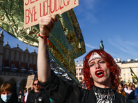 A person holds a banner reading 'Jesus Christ was a refugee' while attending a demonstration against the Polish government's plans to suspen...