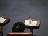 A Shi'ite Iranian cleric sits at the old Iranian Parliament building while taking part in Iran's Assembly of Experts' biannual meeting in Te...