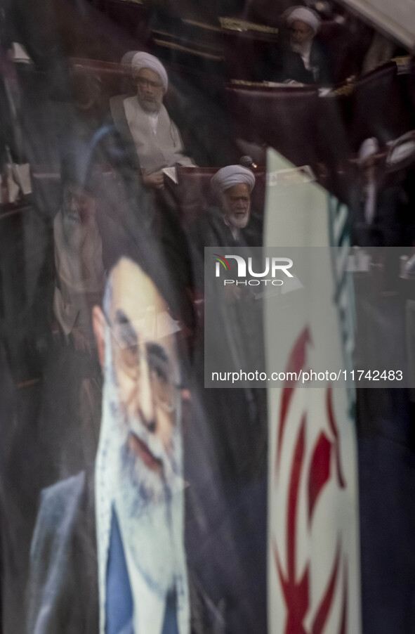 A portrait of Iran's Supreme Leader, Ayatollah Ali Khamenei, is pictured at the old Iranian Parliament building, while Iranian clerics take...