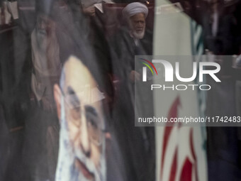 A portrait of Iran's Supreme Leader, Ayatollah Ali Khamenei, is pictured at the old Iranian Parliament building, while Iranian clerics take...