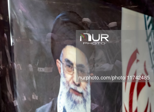 A portrait of Iran's Supreme Leader, Ayatollah Ali Khamenei, is pictured at the old Iranian Parliament building, while Iranian clerics take...