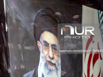 A portrait of Iran's Supreme Leader, Ayatollah Ali Khamenei, is pictured at the old Iranian Parliament building, while Iranian clerics take...