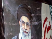 A portrait of Iran's Supreme Leader, Ayatollah Ali Khamenei, is pictured at the old Iranian Parliament building, while Iranian clerics take...