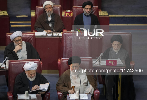 Ultra Conservative Shi'ite Iranian cleric, Ayatollah Sayyid Ahmad Alamolhoda (bottom R), sits at the old Iranian Parliament building while t...