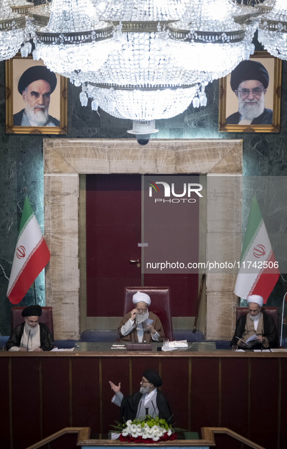 An Iranian cleric gestures while preparing to deliver speeches during Iran's Assembly of Experts' biannual meeting in the old Iranian Parlia...