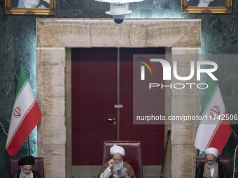 An Iranian cleric gestures while preparing to deliver speeches during Iran's Assembly of Experts' biannual meeting in the old Iranian Parlia...