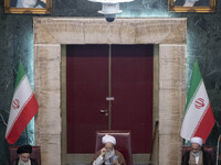 An Iranian cleric gestures while preparing to deliver speeches during Iran's Assembly of Experts' biannual meeting in the old Iranian Parlia...