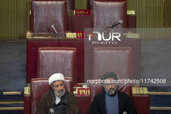 Two Iranian clerics sit at the old Iranian Parliament building during Iran's Assembly of Experts' biannual meeting in Tehran, Iran, on Novem...