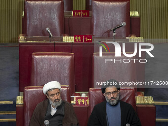 Two Iranian clerics sit at the old Iranian Parliament building during Iran's Assembly of Experts' biannual meeting in Tehran, Iran, on Novem...