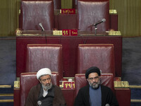 Two Iranian clerics sit at the old Iranian Parliament building during Iran's Assembly of Experts' biannual meeting in Tehran, Iran, on Novem...