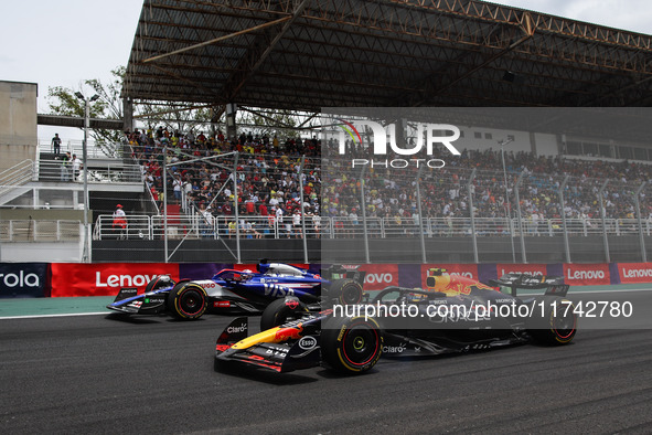 Liam Lawson of Visa Cash App RB F1 Team VCARB 01 and Sergio Perez of Red Bull Racing RB20 participate in the Formula 1 Grand Prix of Brazil...