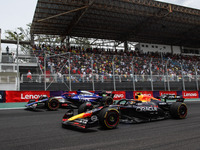 Liam Lawson of Visa Cash App RB F1 Team VCARB 01 and Sergio Perez of Red Bull Racing RB20 participate in the Formula 1 Grand Prix of Brazil...