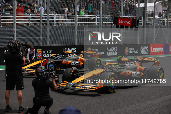 Lando Norris of the McLaren F1 Team MCL38 and Oscar Piastri of the McLaren F1 Team MCL38 participate in the Formula 1 Grand Prix of Brazil a...