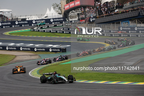 George Russell of the Mercedes AMG F1 Team W15 leads the start of the race ahead of Lando Norris of the McLaren F1 Team MCL38. Yuki Tsunoda...