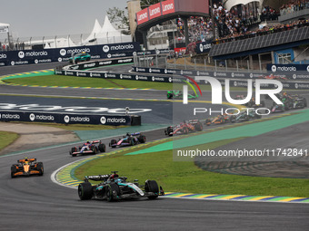 George Russell of the Mercedes AMG F1 Team W15 leads the start of the race ahead of Lando Norris of the McLaren F1 Team MCL38. Yuki Tsunoda...