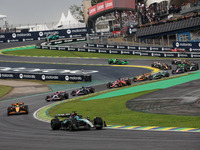 George Russell of the Mercedes AMG F1 Team W15 leads the start of the race ahead of Lando Norris of the McLaren F1 Team MCL38. Yuki Tsunoda...