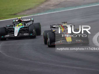 Max Verstappen of Red Bull Racing RB20 and Lewis Hamilton of Mercedes AMG F1 Team W15 compete during the Formula 1 Grand Prix of Brazil at A...