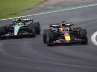 Max Verstappen of Red Bull Racing RB20 and Lewis Hamilton of Mercedes AMG F1 Team W15 compete during the Formula 1 Grand Prix of Brazil at A...