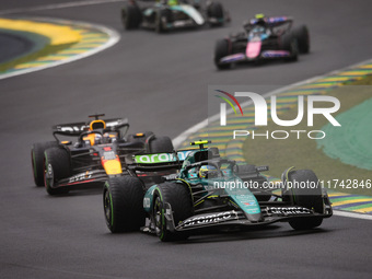 Fernando Alonso of Aston Martin F1 Team AMR24 and Max Verstappen of Red Bull Racing RB20 compete during the Formula 1 Grand Prix of Brazil a...