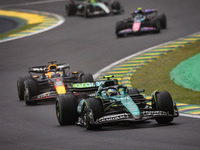 Fernando Alonso of Aston Martin F1 Team AMR24 and Max Verstappen of Red Bull Racing RB20 compete during the Formula 1 Grand Prix of Brazil a...