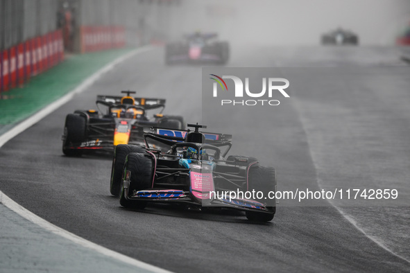 Esteban Ocon of the Alpine F1 Team A524 and Max Verstappen of Red Bull Racing RB20 participate in the Formula 1 Grand Prix of Brazil at Auto...