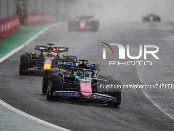 Esteban Ocon of the Alpine F1 Team A524 and Max Verstappen of Red Bull Racing RB20 participate in the Formula 1 Grand Prix of Brazil at Auto...