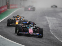 Esteban Ocon of the Alpine F1 Team A524 and Max Verstappen of Red Bull Racing RB20 participate in the Formula 1 Grand Prix of Brazil at Auto...