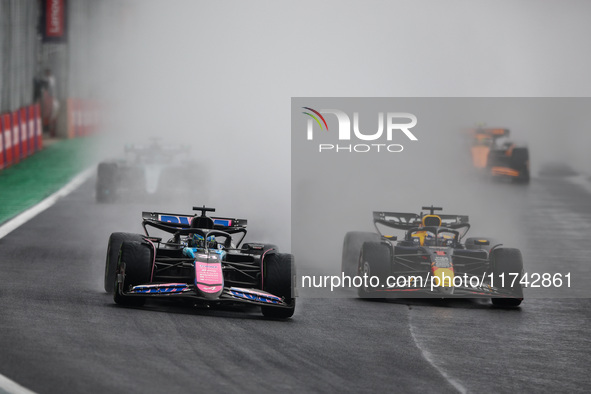 Esteban Ocon of the Alpine F1 Team A524 and Max Verstappen of Red Bull Racing RB20 participate in the Formula 1 Grand Prix of Brazil at Auto...