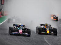 Esteban Ocon of the Alpine F1 Team A524 and Max Verstappen of Red Bull Racing RB20 participate in the Formula 1 Grand Prix of Brazil at Auto...