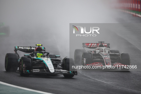 Lewis Hamilton of the Mercedes AMG F1 Team W15 and Oliver Bearman of the Haas F1 Team VF-24 Ferrari participate in the Formula 1 Grand Prix...