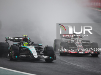 Lewis Hamilton of the Mercedes AMG F1 Team W15 and Oliver Bearman of the Haas F1 Team VF-24 Ferrari participate in the Formula 1 Grand Prix...