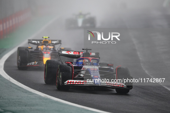 Liam Lawson of Visa Cash App RB F1 Team VCARB 01 and Sergio Perez of Red Bull Racing RB20 participate in the Formula 1 Grand Prix of Brazil...