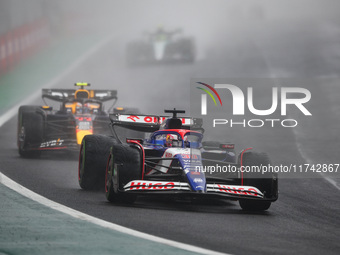 Liam Lawson of Visa Cash App RB F1 Team VCARB 01 and Sergio Perez of Red Bull Racing RB20 participate in the Formula 1 Grand Prix of Brazil...