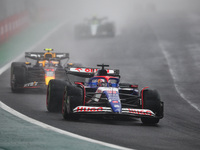 Liam Lawson of Visa Cash App RB F1 Team VCARB 01 and Sergio Perez of Red Bull Racing RB20 participate in the Formula 1 Grand Prix of Brazil...