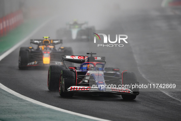 Liam Lawson of Visa Cash App RB F1 Team VCARB 01 and Sergio Perez of Red Bull Racing RB20 participate in the Formula 1 Grand Prix of Brazil...