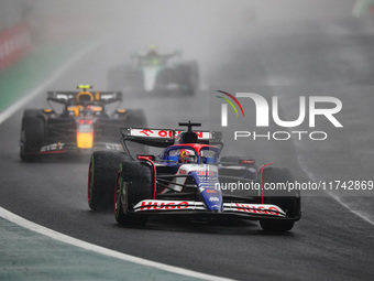 Liam Lawson of Visa Cash App RB F1 Team VCARB 01 and Sergio Perez of Red Bull Racing RB20 participate in the Formula 1 Grand Prix of Brazil...