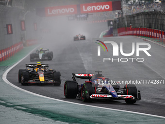 Liam Lawson of Visa Cash App RB F1 Team VCARB 01 and Sergio Perez of Red Bull Racing RB20 participate in the Formula 1 Grand Prix of Brazil...