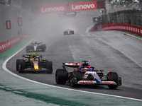 Liam Lawson of Visa Cash App RB F1 Team VCARB 01 and Sergio Perez of Red Bull Racing RB20 participate in the Formula 1 Grand Prix of Brazil...