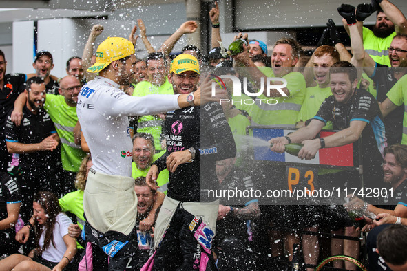 Pierre Gasly and Esteban Ocon of the Alpine F1 Team celebrate the podium with the team during the Formula 1 Grand Prix of Brazil at Autodrom...