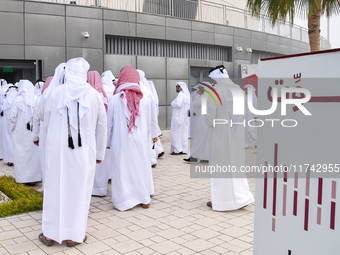 Qatari men arrive at a polling station in Doha, Qatar, on November 5, 2024, to cast their votes in a general referendum on constitutional am...