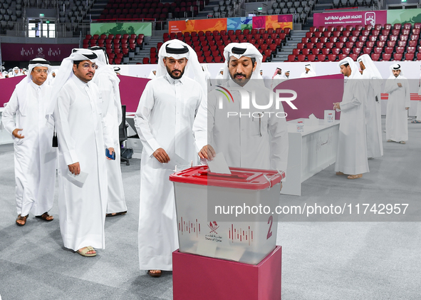 Qatari men cast their votes in ballot boxes at a polling station in a general referendum on constitutional amendments, including scrapping a...