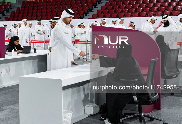 An electoral official checks the identification of a voter at a polling station to take part in a general referendum on constitutional amend...