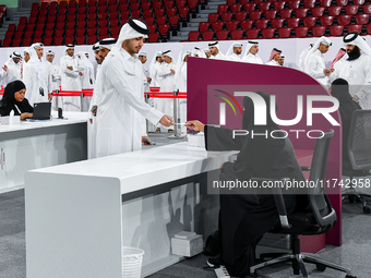 An electoral official checks the identification of a voter at a polling station to take part in a general referendum on constitutional amend...