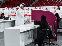 An electoral official checks the identification of a voter at a polling station to take part in a general referendum on constitutional amend...