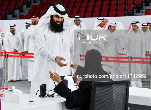 An electoral official checks the identification of a voter at a polling station to take part in a general referendum on constitutional amend...