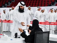 An electoral official checks the identification of a voter at a polling station to take part in a general referendum on constitutional amend...