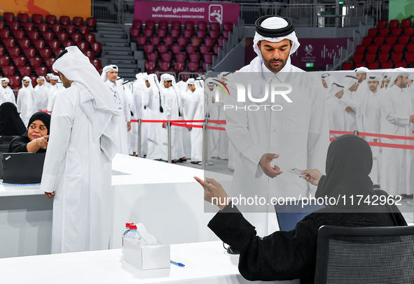 An electoral official checks the identification of a voter at a polling station to take part in a general referendum on constitutional amend...