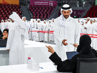 An electoral official checks the identification of a voter at a polling station to take part in a general referendum on constitutional amend...