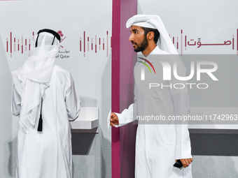 A Qatari man casts his ballot at a polling station in a general referendum on constitutional amendments, including scrapping advisory counci...