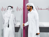 A Qatari man casts his ballot at a polling station in a general referendum on constitutional amendments, including scrapping advisory counci...